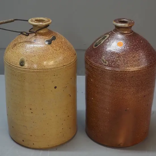 2 narrow-mouth salt-glazed crocks, one marked Luke Adams H310, other has wire handle