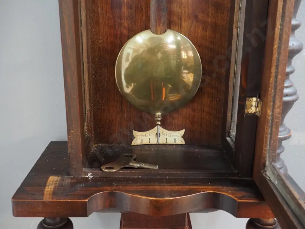 vintage pendulum wall clock in ornate carved mixed timber case w/ turned posts, finials, half ship's wheel, w/key, chip Image 1++