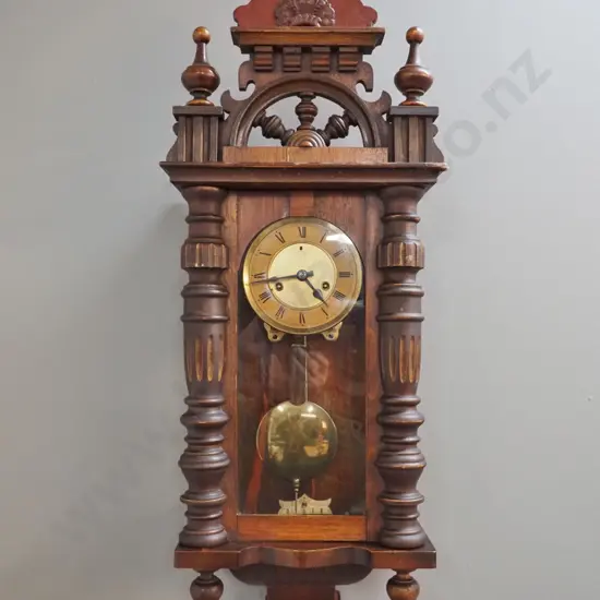 vintage pendulum wall clock in ornate carved mixed timber case w/ turned posts, finials, half ship's wheel, w/key, chip