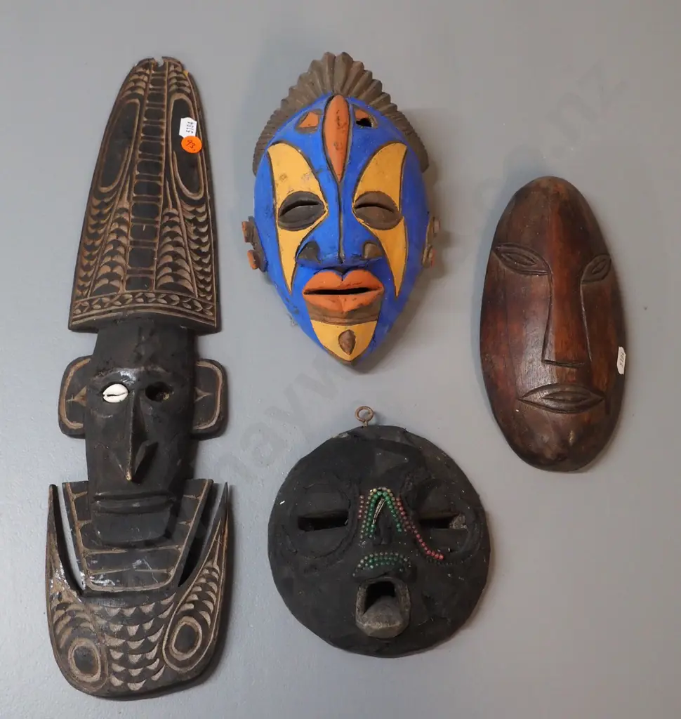 4 wall masks - 3 carved timber, 1 pottery, some damage, wear, missing shell decoration etc. Largest H430 Image 1++