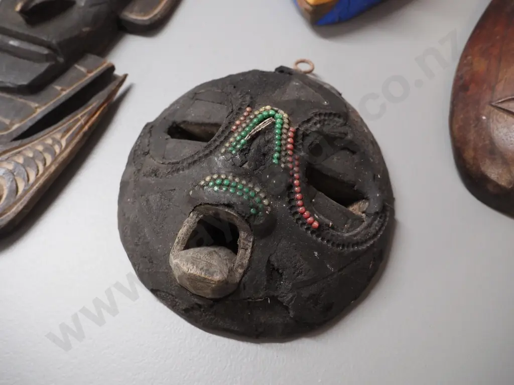 4 wall masks - 3 carved timber, 1 pottery, some damage, wear, missing shell decoration etc. Largest H430 Image 1++