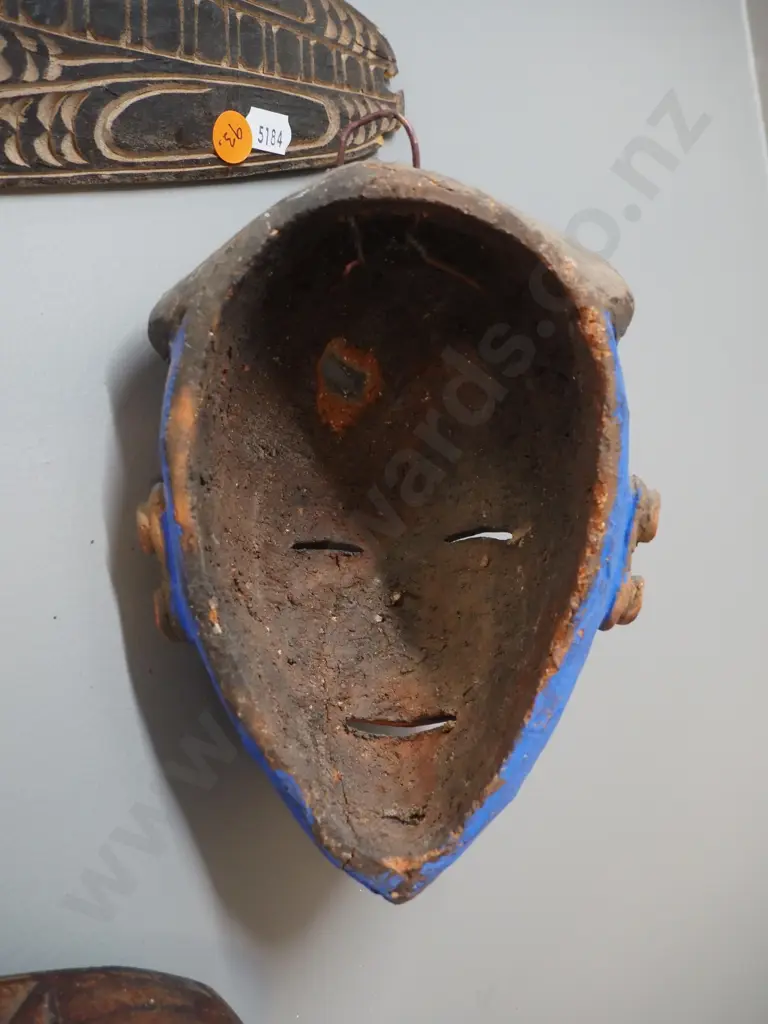 4 wall masks - 3 carved timber, 1 pottery, some damage, wear, missing shell decoration etc. Largest H430 Image 1++