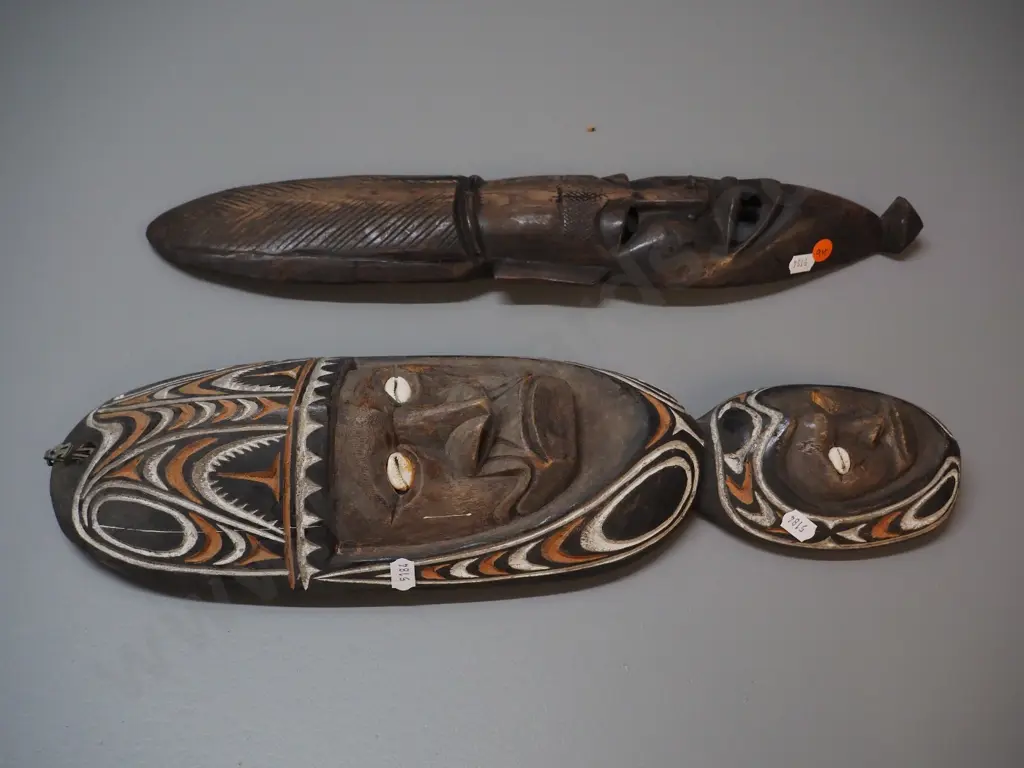 2 carved wooden wall masks - one with shell & painted design, one missing shell. Larger is H-450 W-140 Image 1++