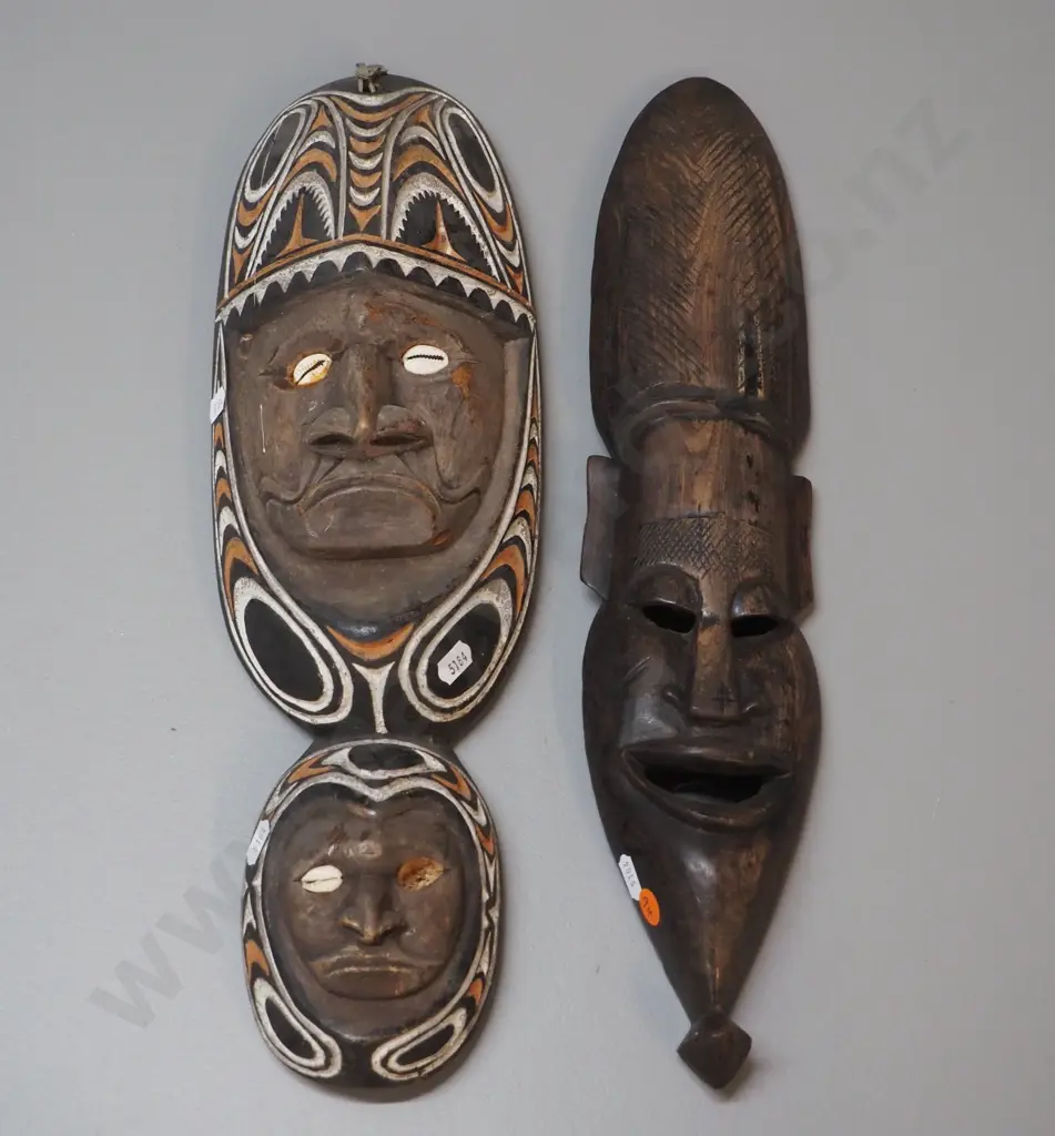 2 carved wooden wall masks - one with shell & painted design, one missing shell. Larger is H-450 W-140 Image 1++