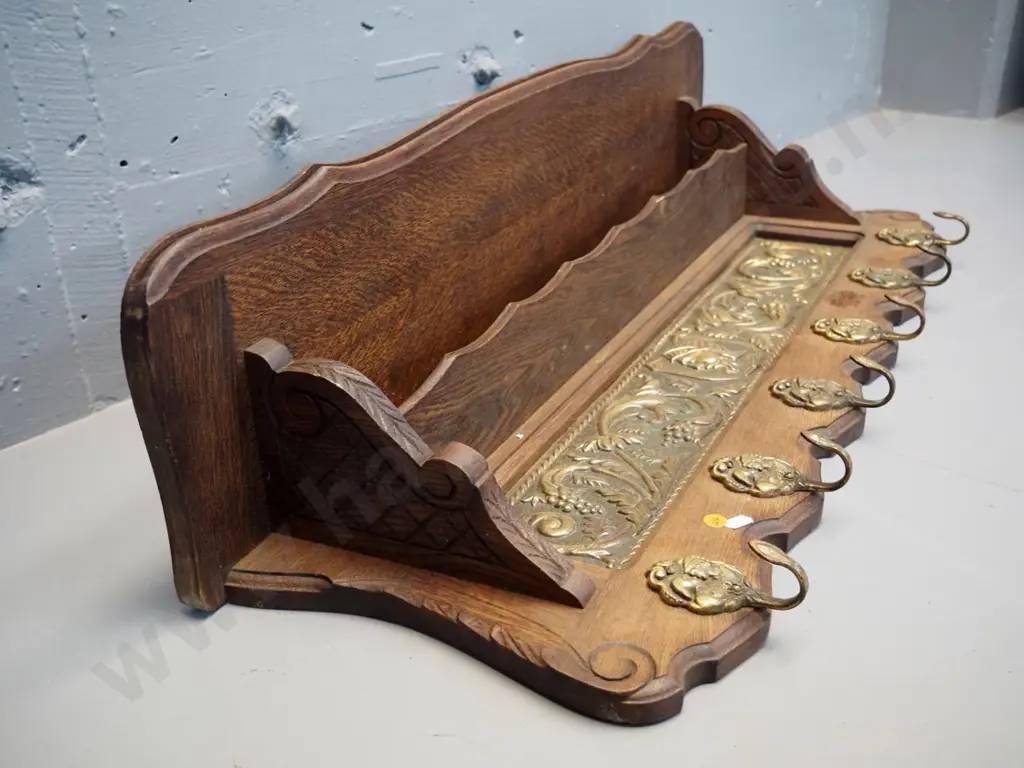 oak wall shelf with pressed brass panel, small lower shelf, and figural cast brass coat hooks H-350 W-850 D-200 Image 1++