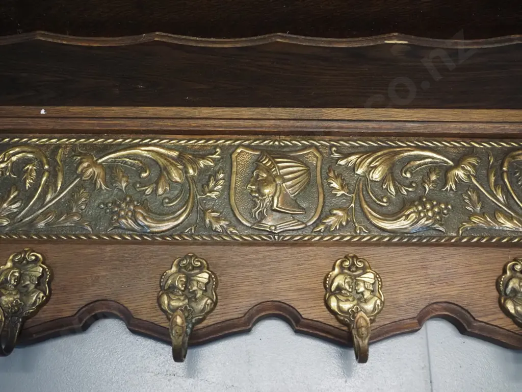 oak wall shelf with pressed brass panel, small lower shelf, and figural cast brass coat hooks H-350 W-850 D-200 Image 1++