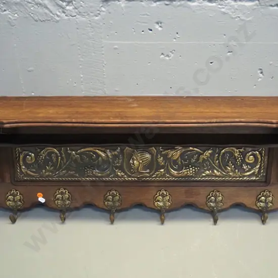 oak wall shelf with pressed brass panel, small lower shelf, and figural cast brass coat hooks H-350 W-850 D-200