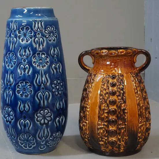 2 high-glaze German pottery vases - brown one marked Relief 62-21, blue one is H-310