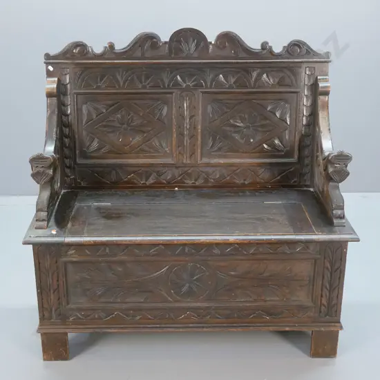 antique oak settle with lift-up seat, ornately carved front, back and arms H-1060 W-1060 D-460