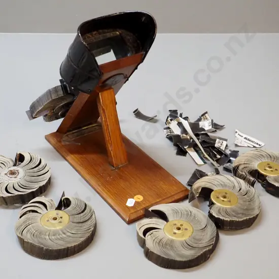 Kinora hand-crank motion picture viewer on wooden base, with 6 flip-picture reels - working condition, one reel