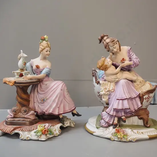2 Capodimonte Viertosca sitting figurines - woman with baby, woman pouring tea, each approx. H-240