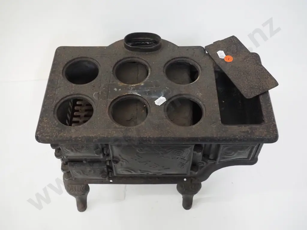 miniature cast iron stove marked "Baby" and Ideal Manufacturing Co. Detroit - missing end plate or door and hot plates Image 1++