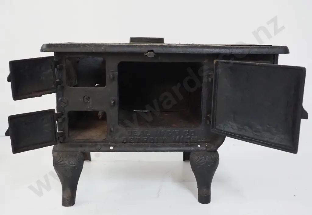 miniature cast iron stove marked "Baby" and Ideal Manufacturing Co. Detroit - missing end plate or door and hot plates Image 1++