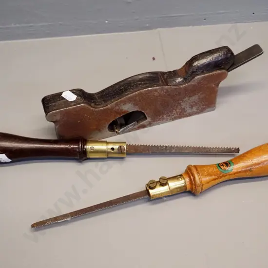 3 hand tools - corroded steel and wood plane and 2 brass and wood-handled keyhole saws Elliot Lewis Elvicta