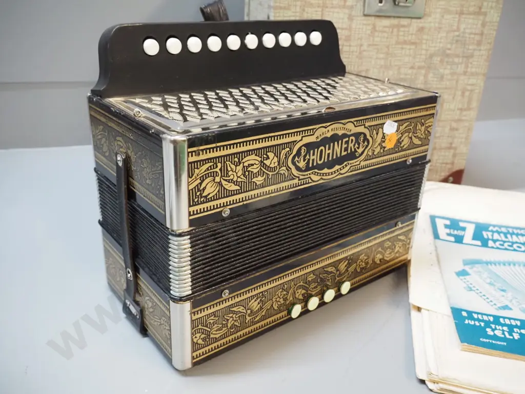 vintage Hohner button accordion, hard case and assorted instructional sheet music - accordion in very good condition Image 1++