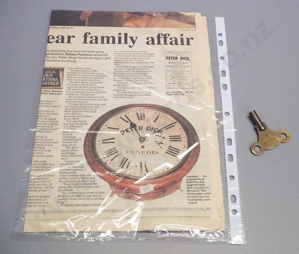 antique timber cased wall clock with brass bezel, with key, faded Peter Dick / Dunedin markings on face plus newspaper Image 1++