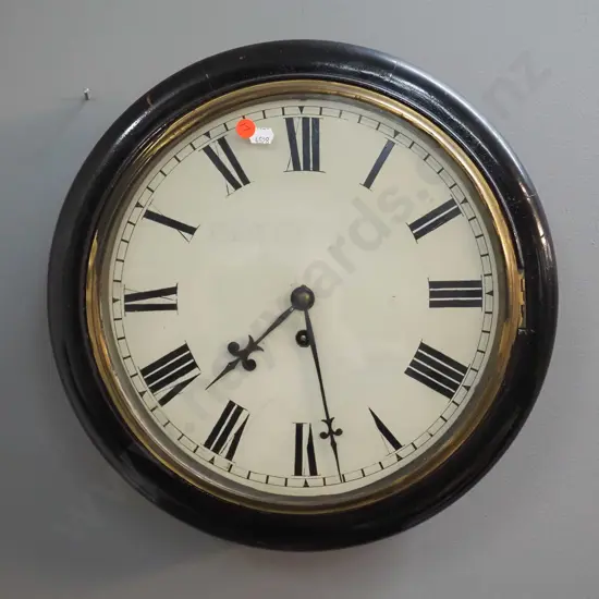 antique timber cased wall clock with brass bezel, with key, faded Peter Dick / Dunedin markings on face plus newspaper