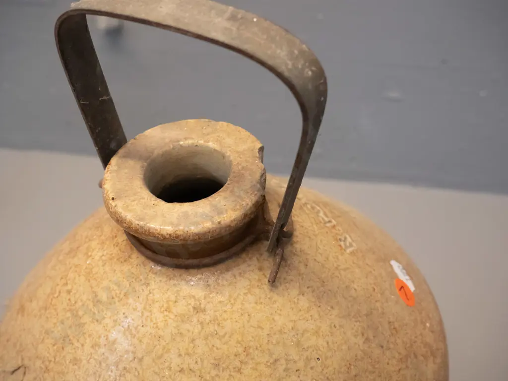 narrow-mouth crock with metal handle, marked R Powley & Co Dunedin 2669, chip to rim. No tap. H460 D220 Image 1++