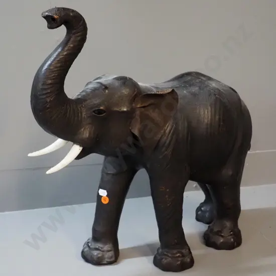 large leather covered elephant figure with plastic tusks, plastic or glass eyes - some wear to leather finish H470 L550