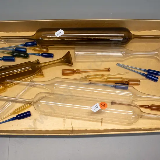 assorted delicate laboratory glassware items, coloured and clear, longest pipette is L-350
