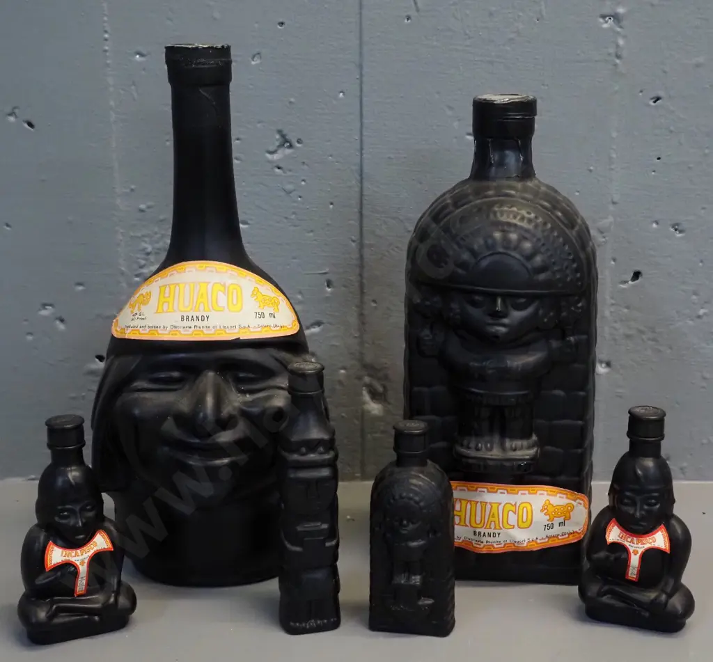 Huaco Italian brandy in figural black glass bottles - two 750ml bottles and 4 miniatures, sealed with contents Image 1++