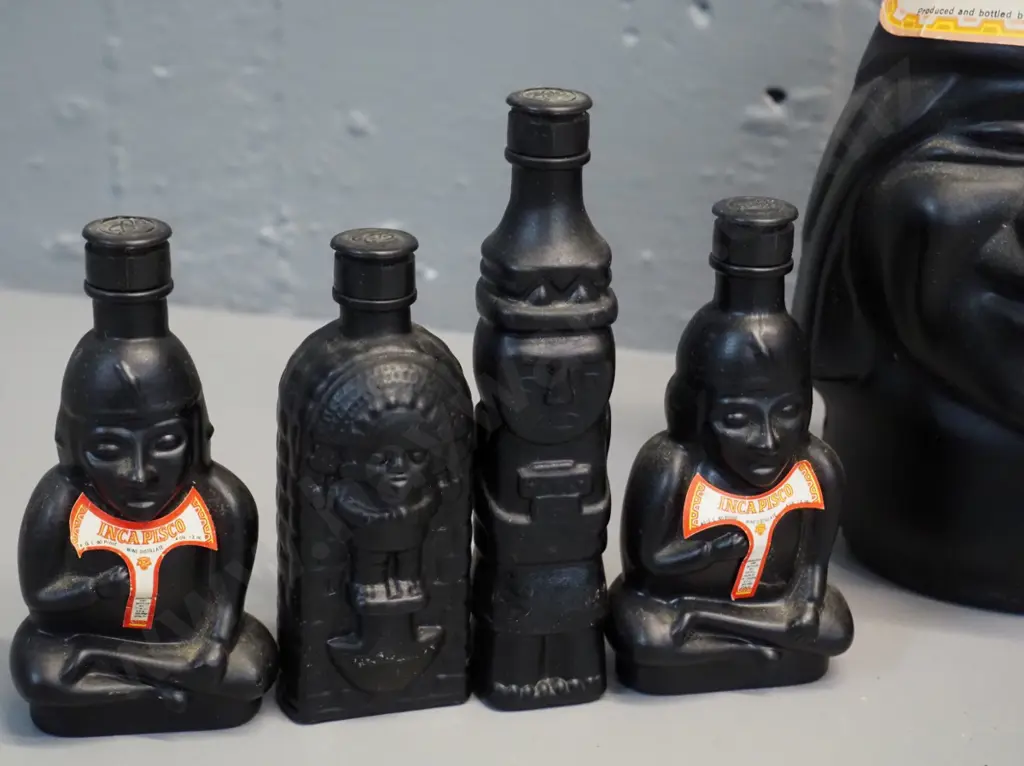 Huaco Italian brandy in figural black glass bottles - two 750ml bottles and 4 miniatures, sealed with contents Image 1++