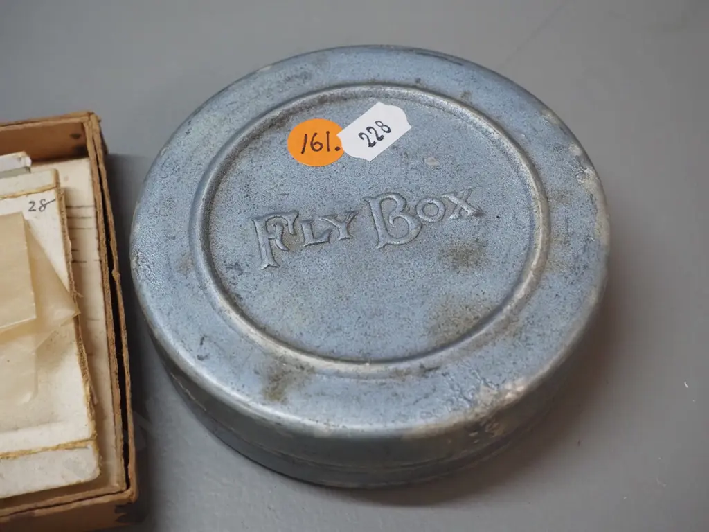 aluminium tin of fishing flies marked "Fly Box" in relief D-110 and a box of flies marked Walbrans trout and grayling Image 1++