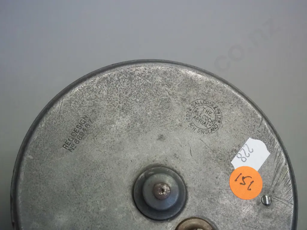 aluminium & brass aerial fishing reel marked Allcocks Redditch 4 1/2 inch - one timber knob missing - diameter 120 Image 1++