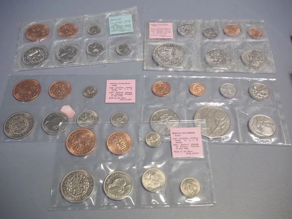 assorted New Zealand uncirculated coin sets, commemorative dollars and a 1965 English Churchill coin Image 1++
