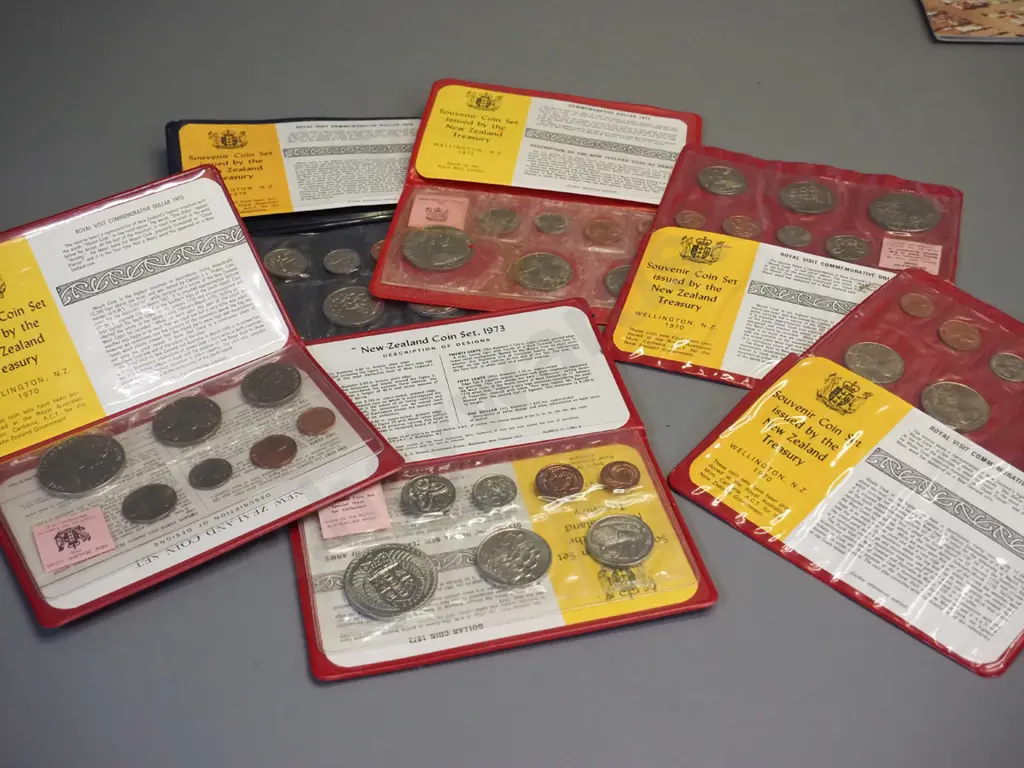 assorted New Zealand uncirculated coin sets, commemorative dollars and a 1965 English Churchill coin Image 1++