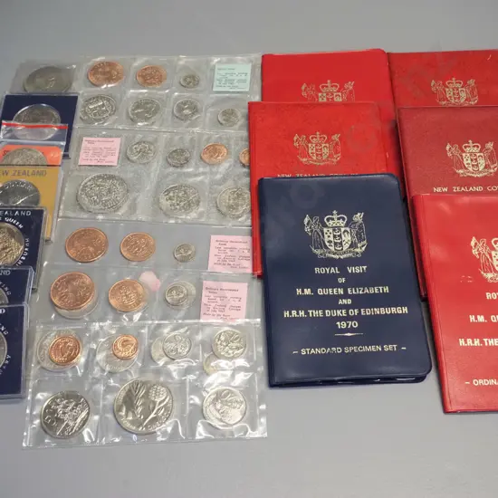 assorted New Zealand uncirculated coin sets, commemorative dollars and a 1965 English Churchill coin