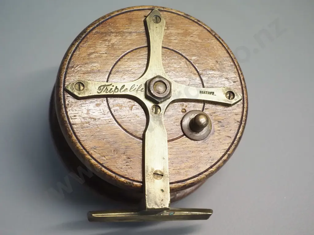 timber and brass fishing reel marked Heatons Triple Life - w/bakelite knobs. Diameter 115 Image 1++