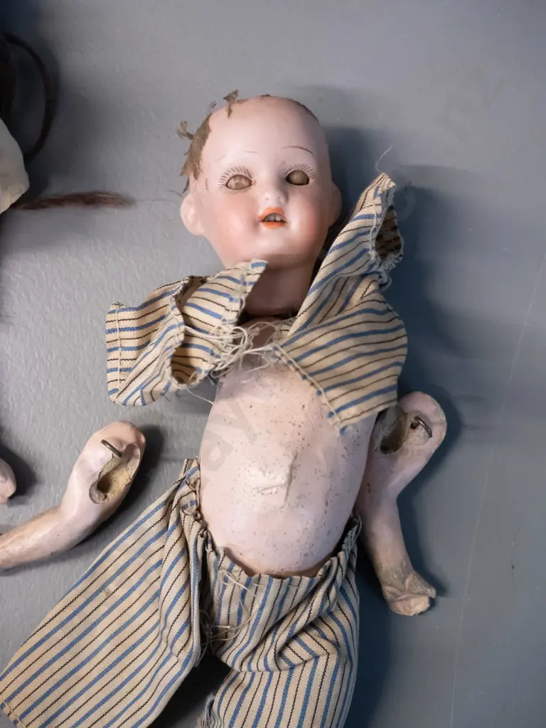 2 antique porcelain dolls - limbs seperated, one has broken arm, smaller one missing top of head. Larger is H-400 Image 1++