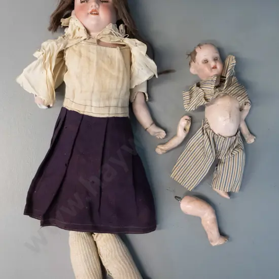 2 antique porcelain dolls - limbs seperated, one has broken arm, smaller one missing top of head. Larger is H-400
