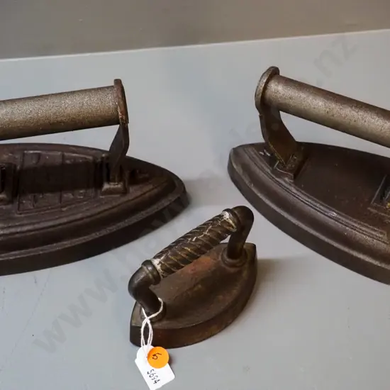 3 cast iron items - 2 sad irons - one unmarked, one Silvesters H120 L170 and a collar & cuff iron, no maker's mark