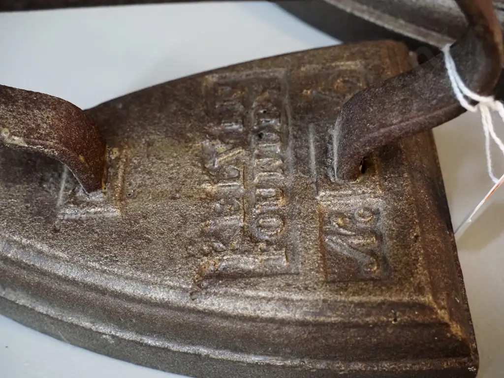 cast iron items - 2 sad irons - one marked Calvin Foundry H110 L160, other Silvesters - and a shoe last Image 1++