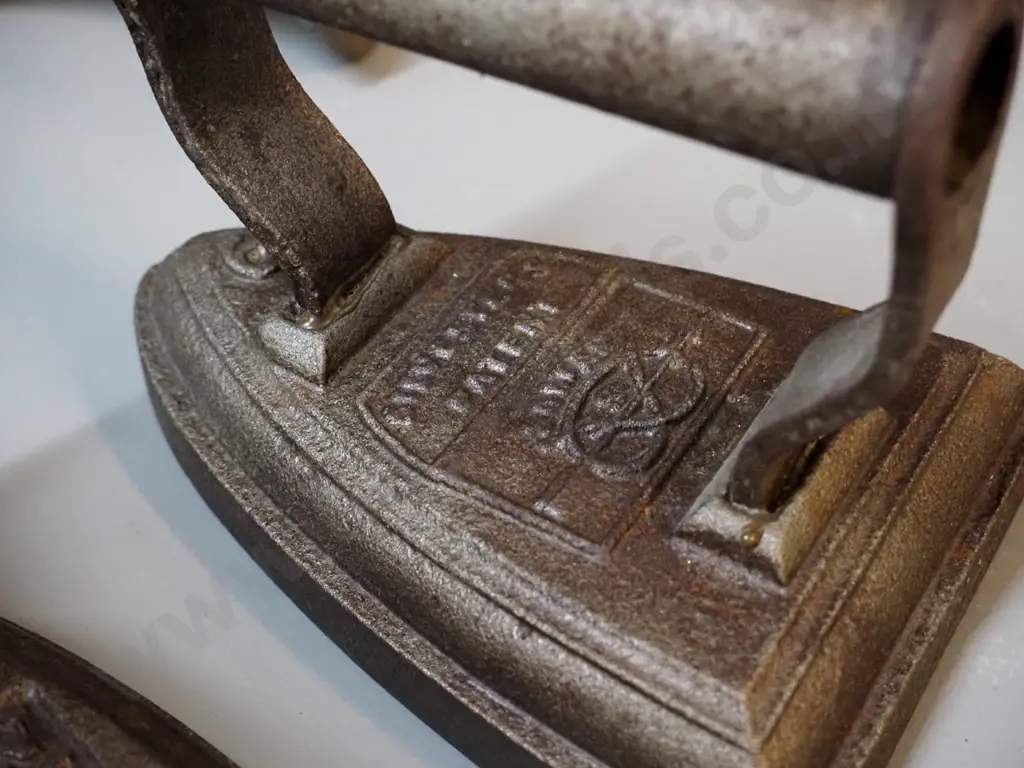 cast iron items - 2 sad irons - one marked Calvin Foundry H110 L160, other Silvesters - and a shoe last Image 1++