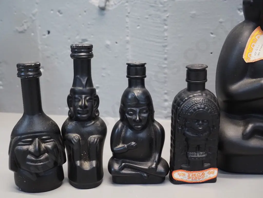 Huaco Italian brandy in figural black glass bottles - two 750ml bottles and 4 miniatures, sealed with contents Image 1++