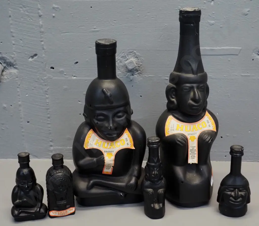 Huaco Italian brandy in figural black glass bottles - two 750ml bottles and 4 miniatures, sealed with contents Image 1++