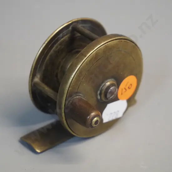 small brass fishing reel marked Chas. Farlow, 191 Strand, London - circa 1890 according to label - diameter 55