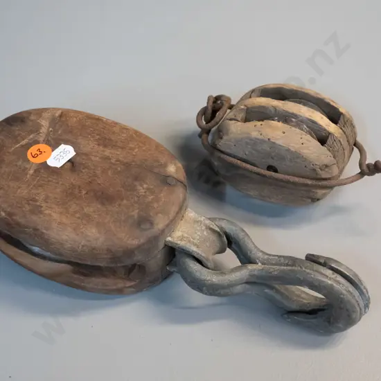 2 vintage wood and metal pulleys, one has corrosion and borer holes, larger one is L-240