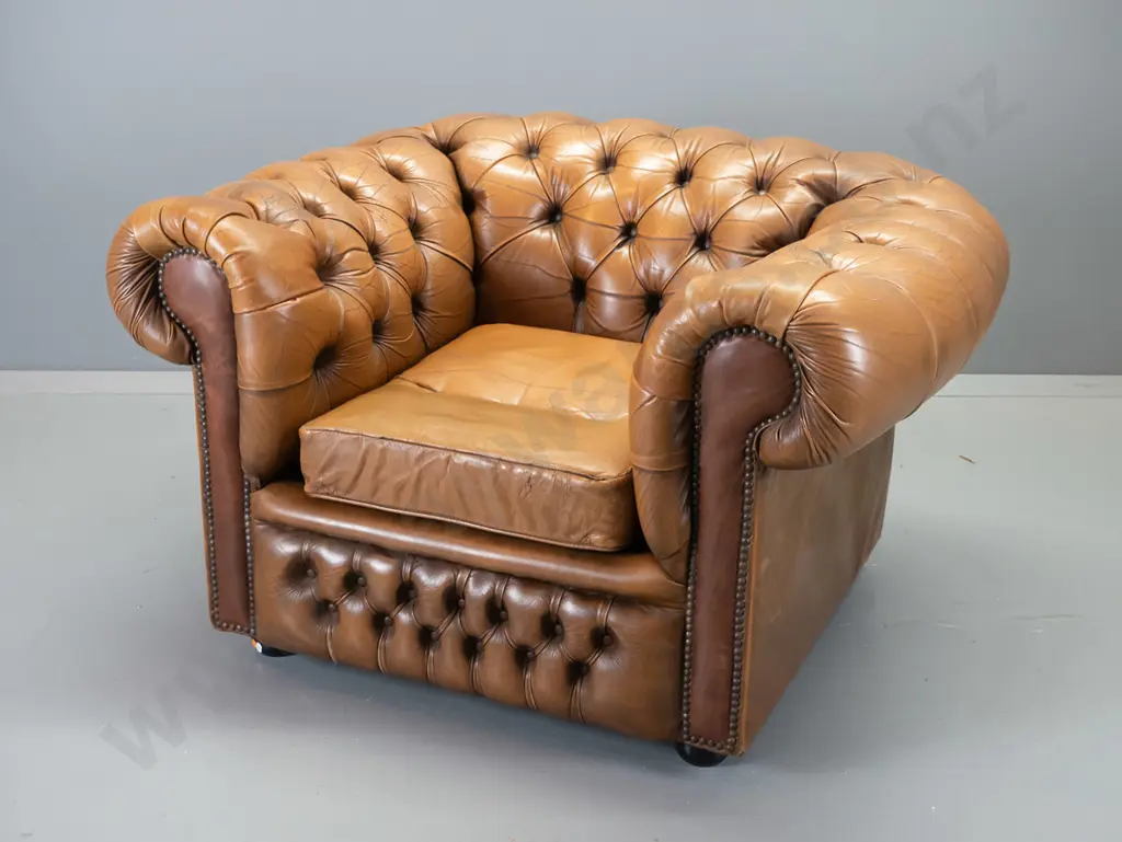 deep-button rolled arm chesterfield style chair w/ball feet, covered in antiqued-finish leather, surface cracking to Image 1++