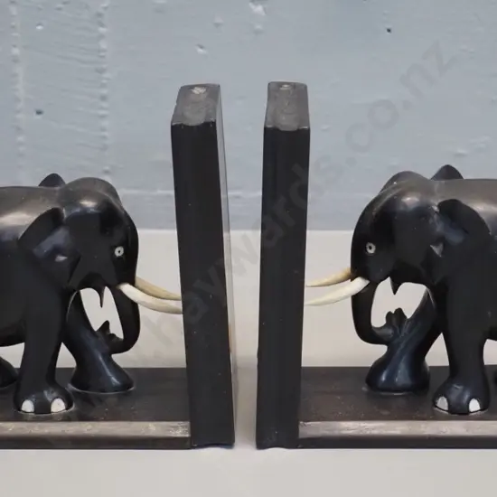 pair of ebonised timber elephant book-ends - one has crack to timber - each H-150 L-170
