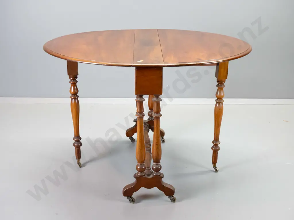 antique mahogany oval drop-side table with original metal casters, stretcher base, polish uneven on top Image 1++