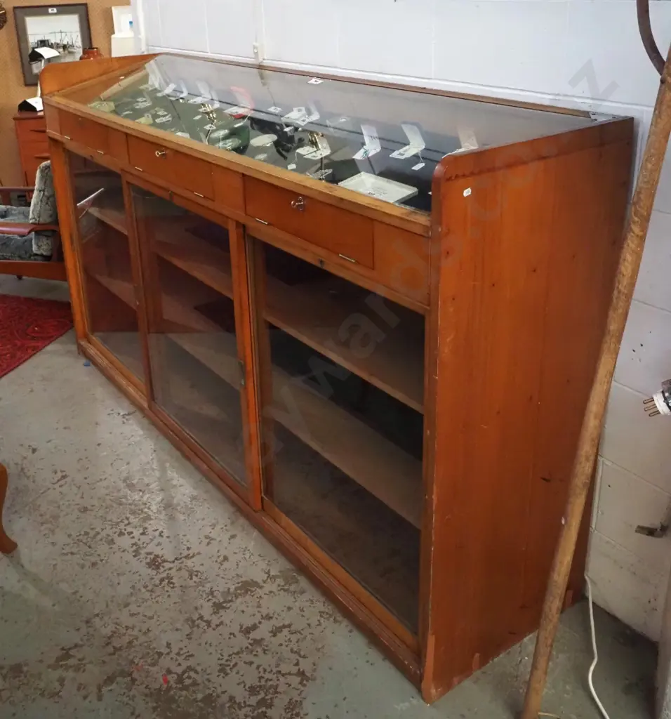 large kauri shop display cabinet with sloping glass top w/3 access flaps & 3 sliding doors in base, all lockable, with Image 1++