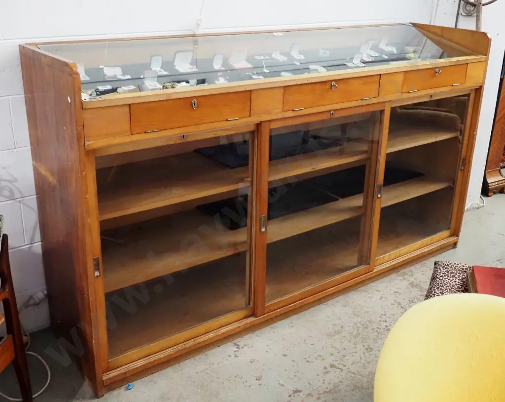 large kauri shop display cabinet with sloping glass top w/3 access flaps & 3 sliding doors in base, all lockable, with Image 1++