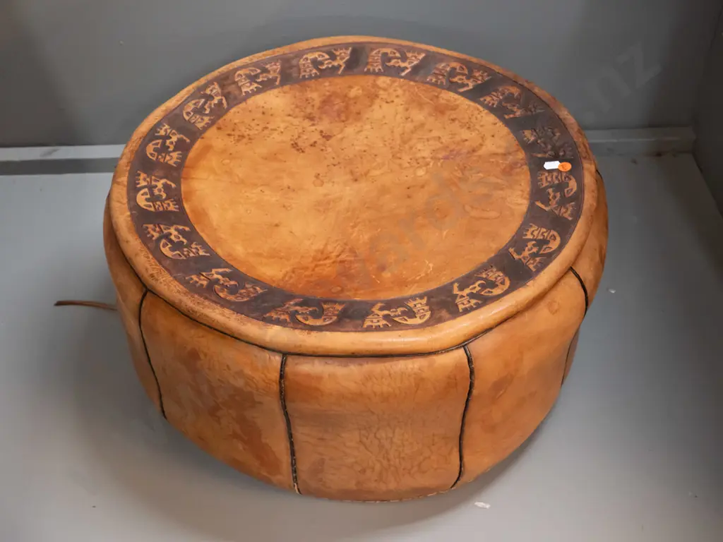 middle eastern leather pouffe with embossed pattern top, one side handle, aged finish H-280 D-540 Image 1++
