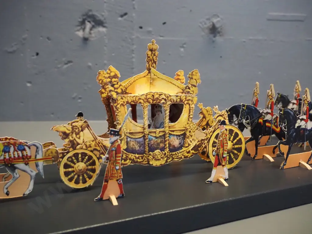 paper cut-out set of the 1953 Coronation procession of Queen Elizabeth II - mounted with wooden supports to a painted Image 1++