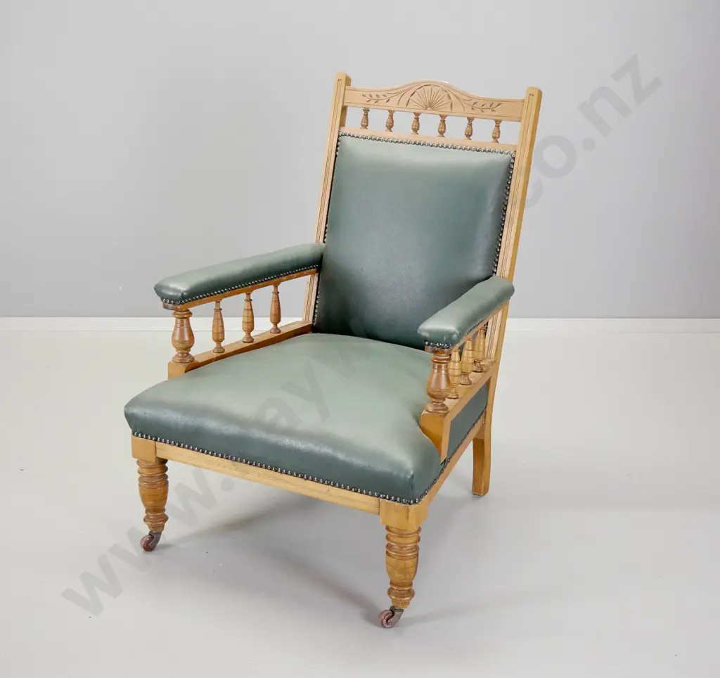 Edwardian kauri armchair with spindle and carved back rail, covered in studded green leather H-950 W-680 D-730 Image 1++