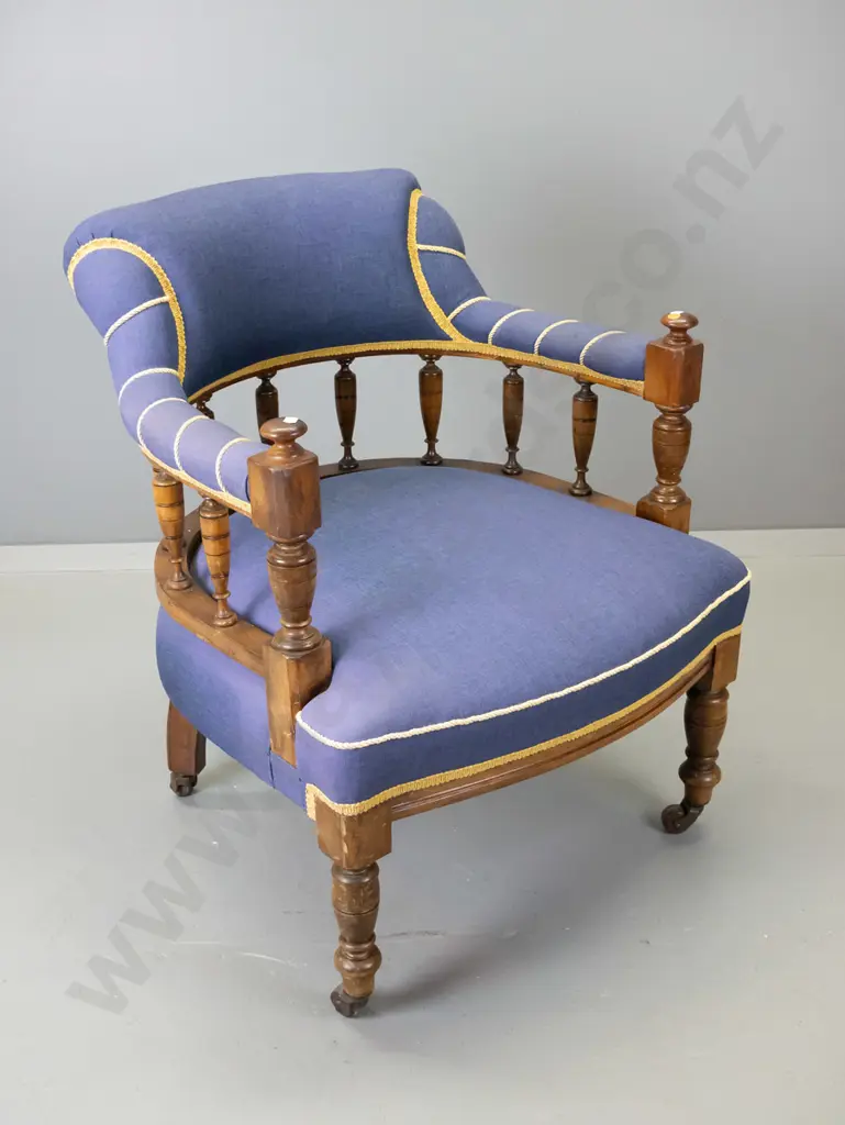 Edwardian mahogany spindle-back tub chair covered in plain weave fabric w/gold corded highlighting, on porcelain casters Image 1++